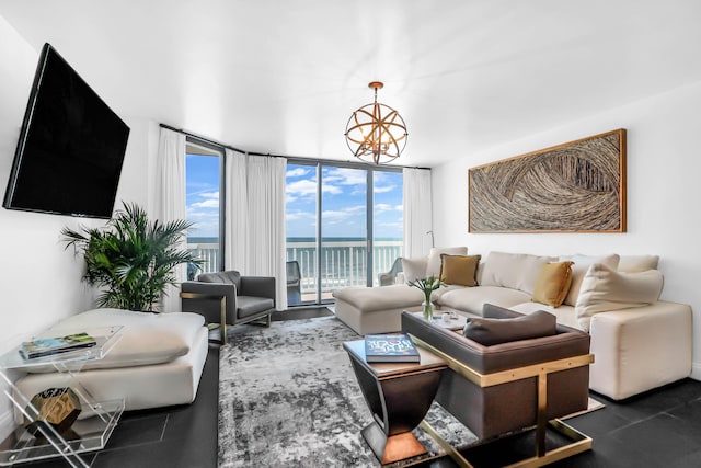 living room featuring a water view, floor to ceiling windows, and a notable chandelier