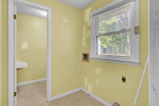laundry room featuring laundry area, tile patterned flooring, hookup for an electric dryer, washer hookup, and baseboards