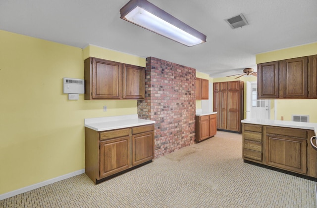 kitchen with ceiling fan, visible vents, light carpet, light countertops, and baseboards