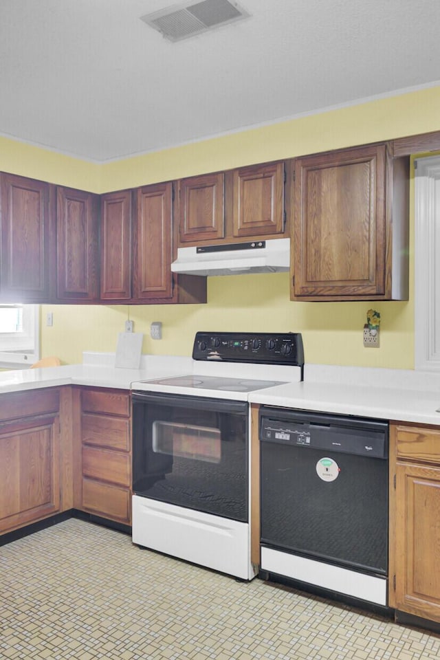 kitchen featuring visible vents, dishwasher, light countertops, under cabinet range hood, and electric range