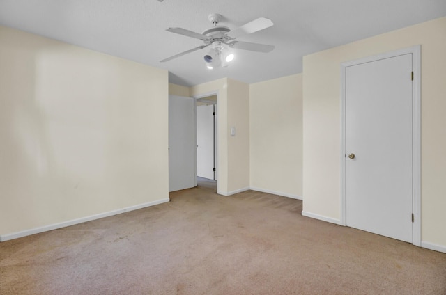 unfurnished bedroom featuring baseboards, a ceiling fan, and carpet floors