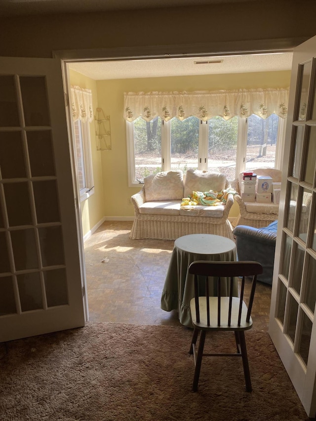 sitting room with visible vents and baseboards