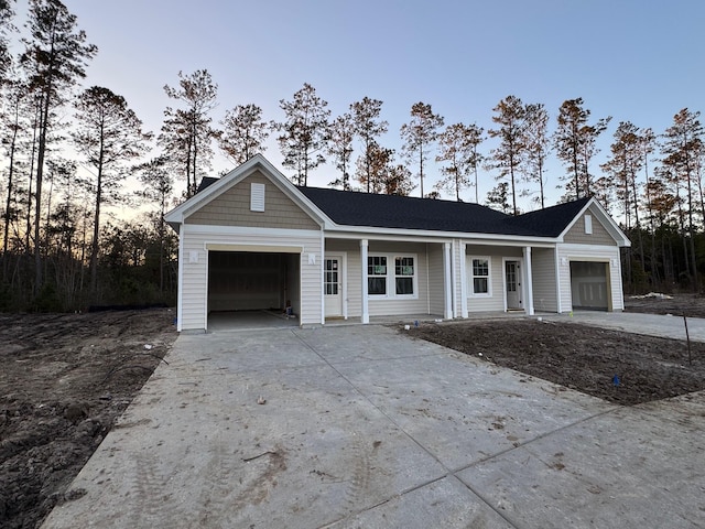 ranch-style home featuring a garage and a porch