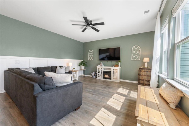 living room with hardwood / wood-style flooring and ceiling fan