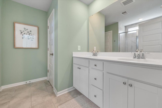 bathroom with vanity and a shower with shower door