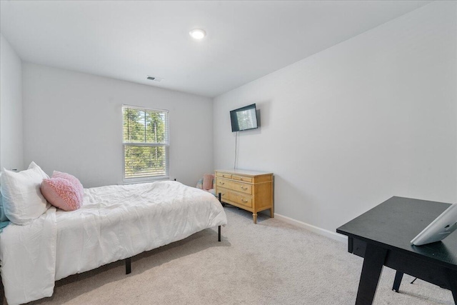 bedroom with light colored carpet