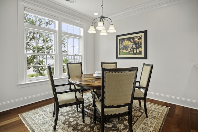 dining area featuring crown molding, dark hardwood / wood-style floors, and an inviting chandelier