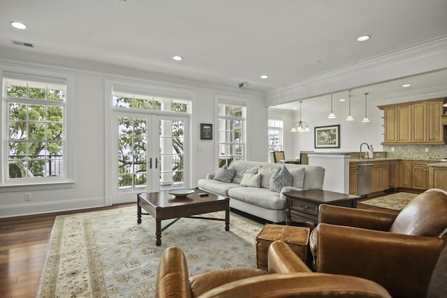 living room featuring crown molding, plenty of natural light, and dark wood-type flooring