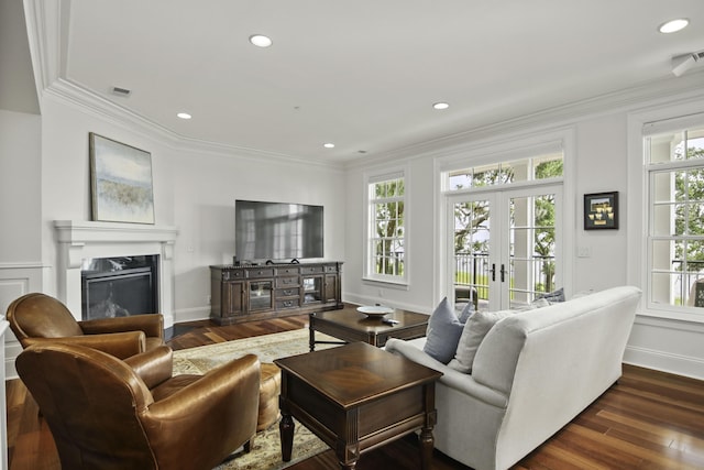 living room with crown molding, dark wood-type flooring, and french doors