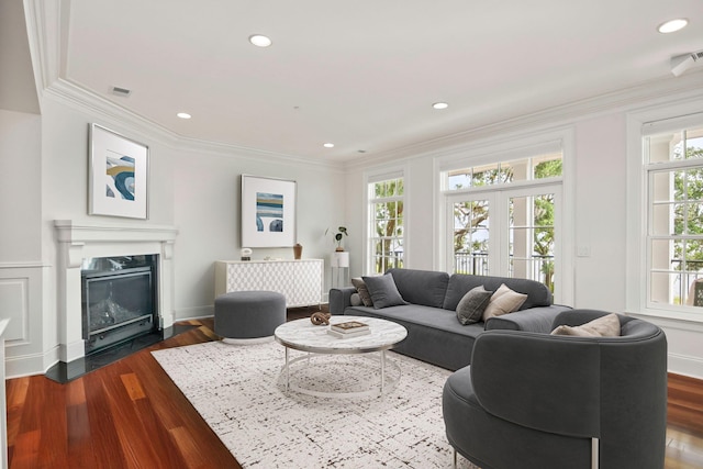 living room with dark wood-type flooring and ornamental molding