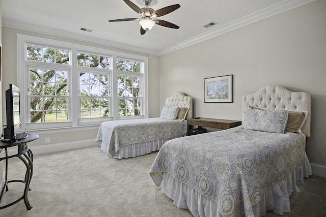 carpeted bedroom with ceiling fan, ornamental molding, and multiple windows