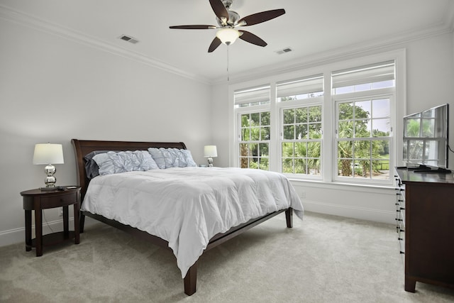 carpeted bedroom featuring crown molding and ceiling fan