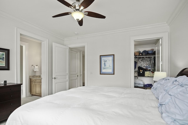 bedroom featuring ensuite bathroom, a walk in closet, ornamental molding, a closet, and ceiling fan