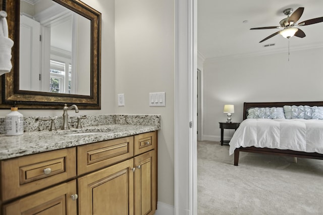 bedroom with crown molding, sink, and light carpet