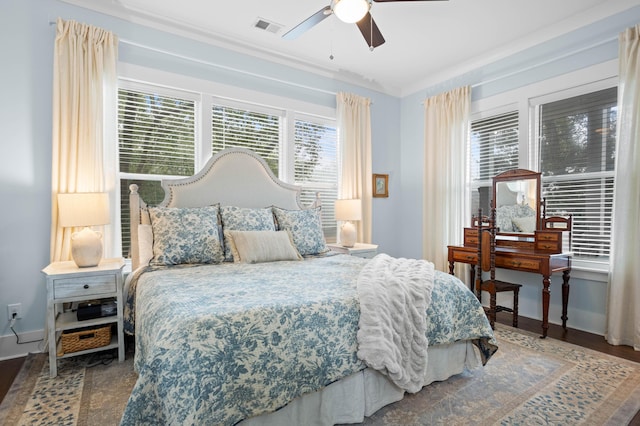 bedroom featuring ceiling fan, ornamental molding, and hardwood / wood-style floors