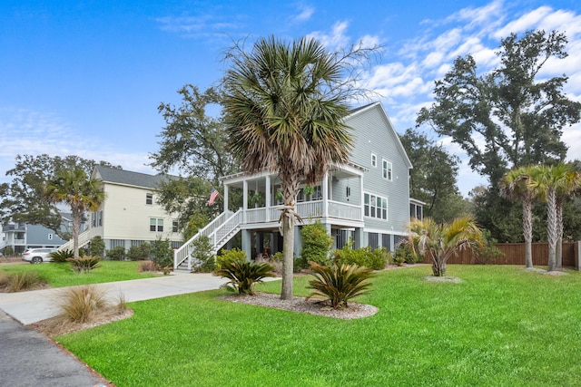 view of front of property featuring a front yard and a sunroom