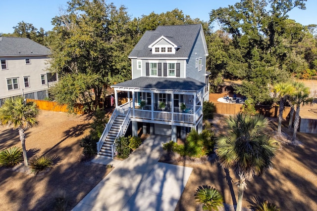 view of front facade with a porch, a garage, and a sunroom