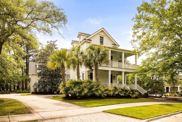 11 Dalton St, Daniel Island, SC 29492 - view of front facade featuring a porch, ceiling fan, a front yard, a balcony, and driveway