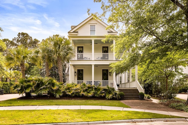 11 Dalton St, Daniel Island, SC 29492 - view of front of house with a ceiling fan, covered porch, a balcony, and a front lawn