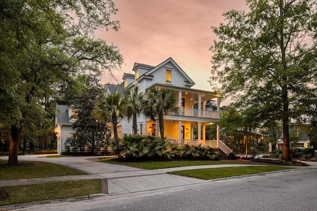 11 Dalton St, Daniel Island, SC 29492 - view of front of property with covered porch, a balcony, asphalt driveway, and a front yard