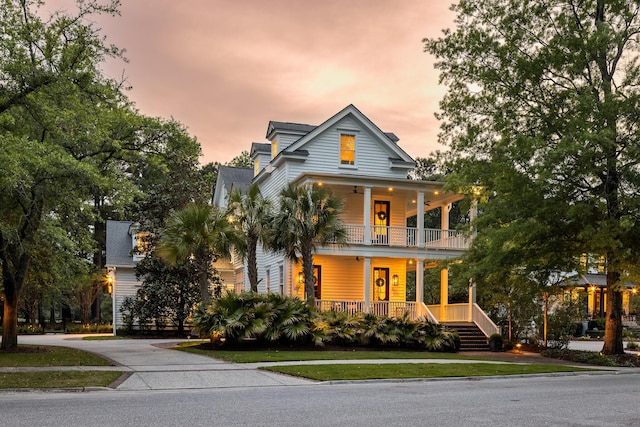 11 Dalton St, Daniel Island, SC 29492 - view of front of home featuring a balcony, covered porch, and a front yard