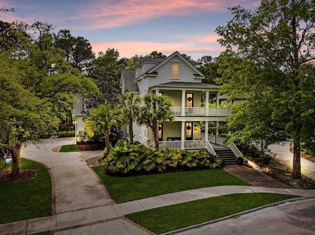 11 Dalton St, Daniel Island, SC 29492 - view of front facade with a porch, roof with shingles, a front lawn, and driveway