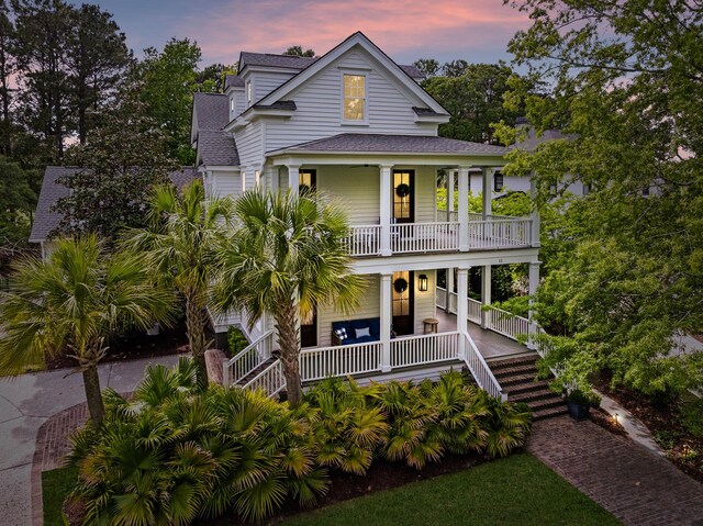 11 Dalton St, Daniel Island, SC 29492 - view of front facade with covered porch, a shingled roof, stairway, and a balcony