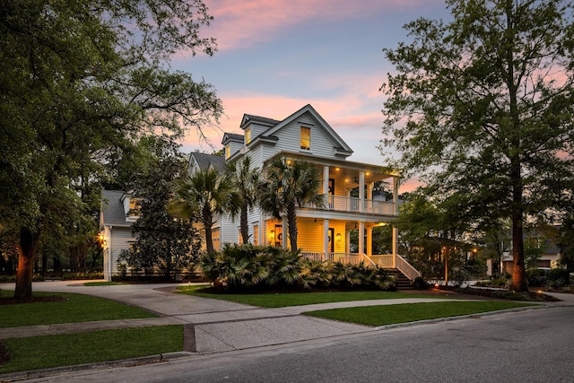 11 Dalton St, Daniel Island, SC 29492 - view of front of property with covered porch, a balcony, driveway, and a lawn