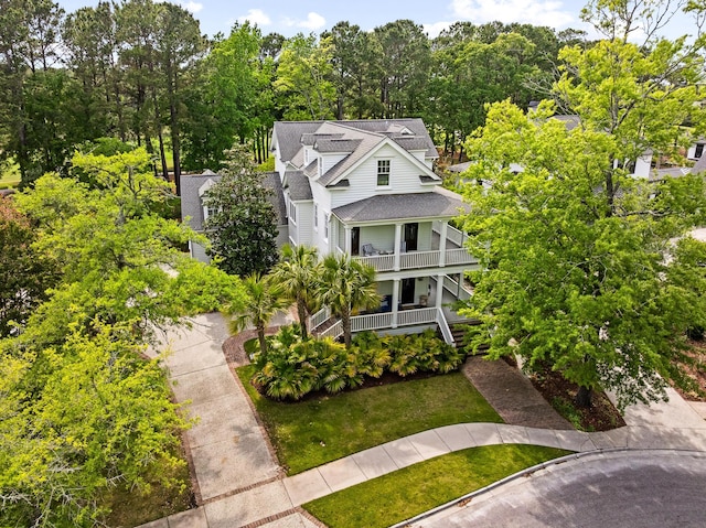 11 Dalton St, Daniel Island, SC 29492 - view of front facade with roof with shingles, stairs, a front lawn, a balcony, and a porch