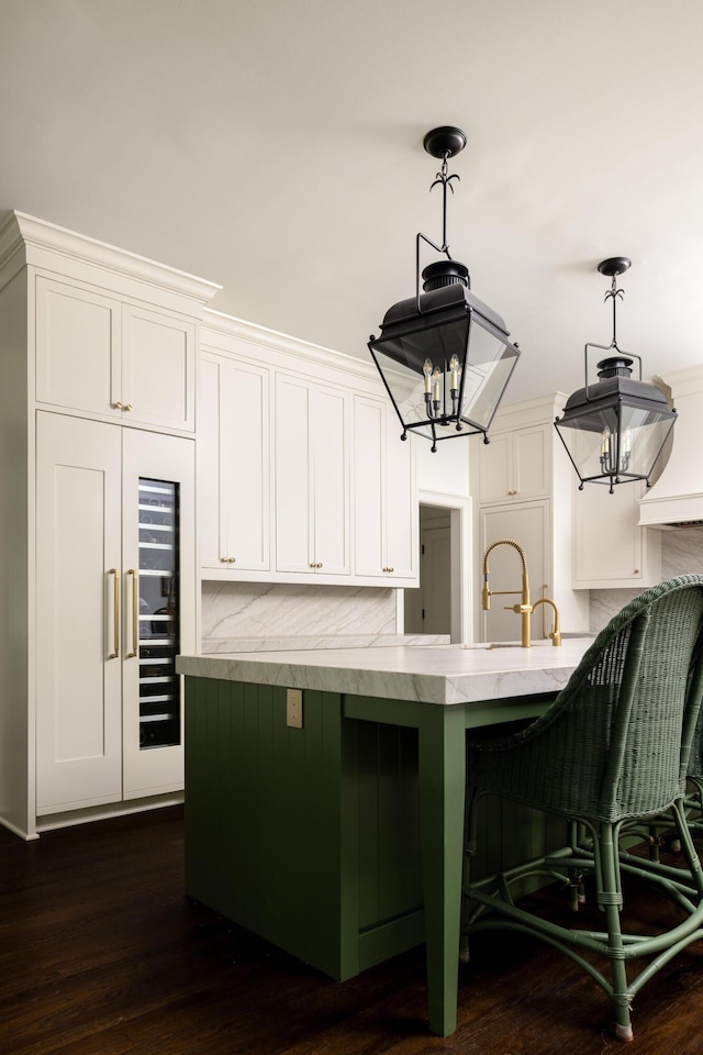 11 Dalton St, Daniel Island, SC 29492 - kitchen featuring white cabinets, hanging light fixtures, and a kitchen bar