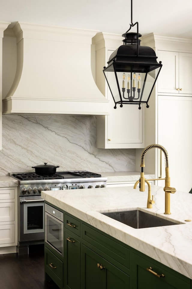 11 Dalton St, Daniel Island, SC 29492 - kitchen with green cabinets, a sink, light stone counters, and crown molding