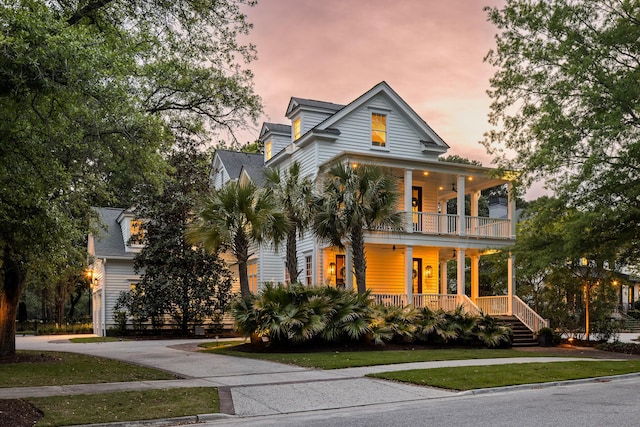11 Dalton St, Daniel Island, SC 29492 - view of front facade featuring covered porch, a balcony, and a yard