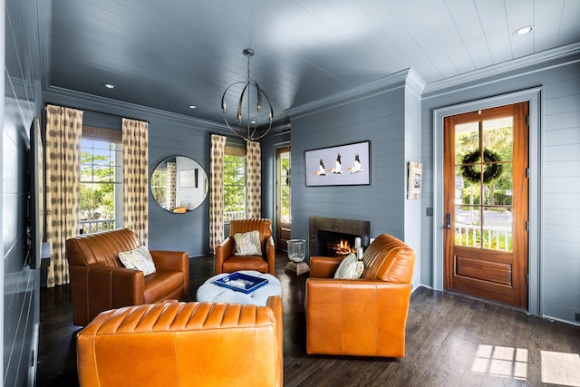 11 Dalton St, Daniel Island, SC 29492 - living room with crown molding, plenty of natural light, wood finished floors, a warm lit fireplace, and wood walls