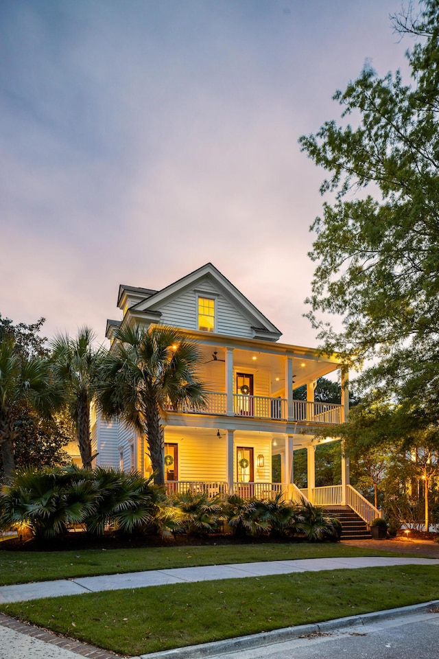 11 Dalton St, Daniel Island, SC 29492 - view of front of home with covered porch, a front yard, and a balcony