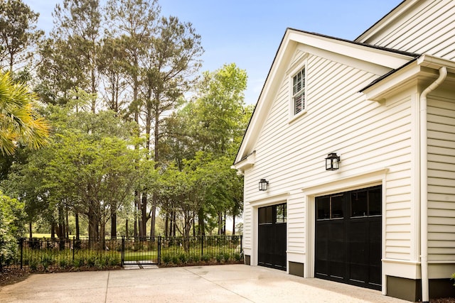 11 Dalton St, Daniel Island, SC 29492 - view of home's exterior featuring a garage, concrete driveway, and fence
