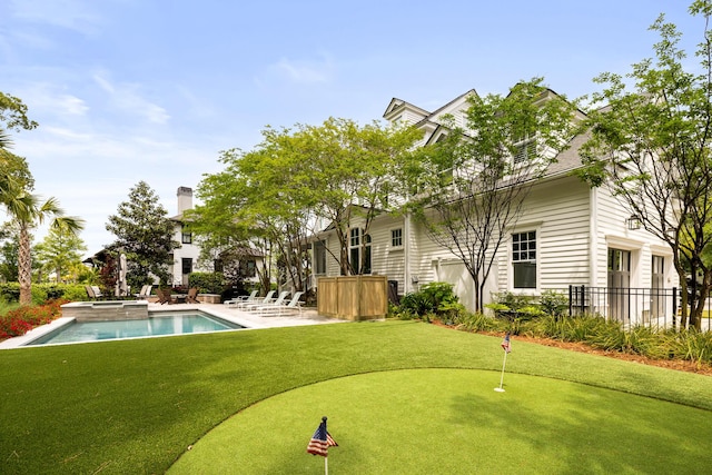 11 Dalton St, Daniel Island, SC 29492 - back of house featuring an area to practice putting, a patio area, fence, and a pool with connected hot tub