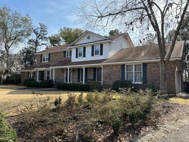 traditional-style house with brick siding and covered porch
