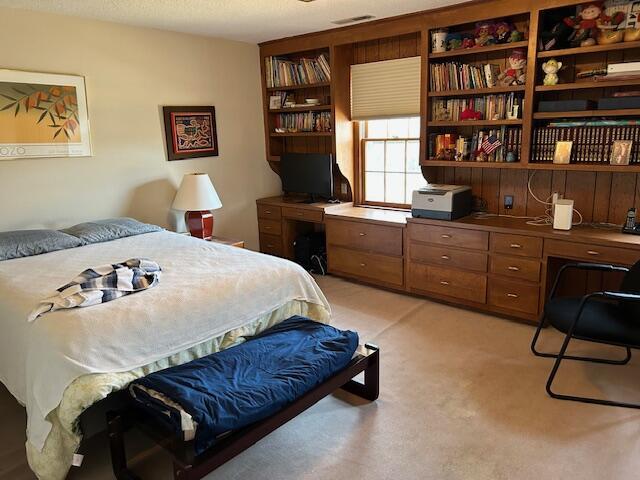 bedroom with light colored carpet