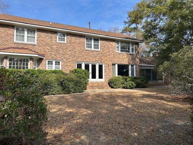 rear view of property featuring brick siding