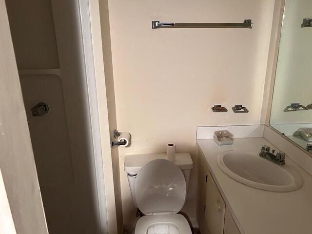 bathroom featuring toilet and vanity