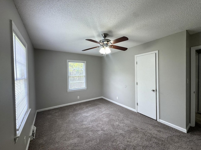 36 Guerry Cir, Goose Creek, SC 29445 - unfurnished bedroom with dark colored carpet, baseboards, a textured ceiling, and ceiling fan