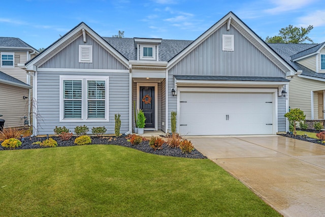 view of front of property featuring a garage and a front yard