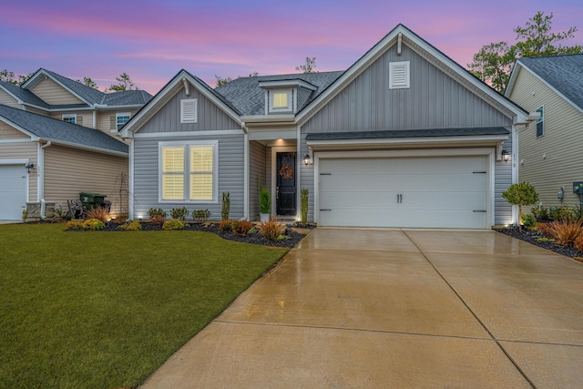 craftsman house featuring a garage and a lawn