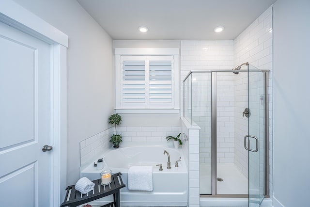 bathroom with shower with separate bathtub