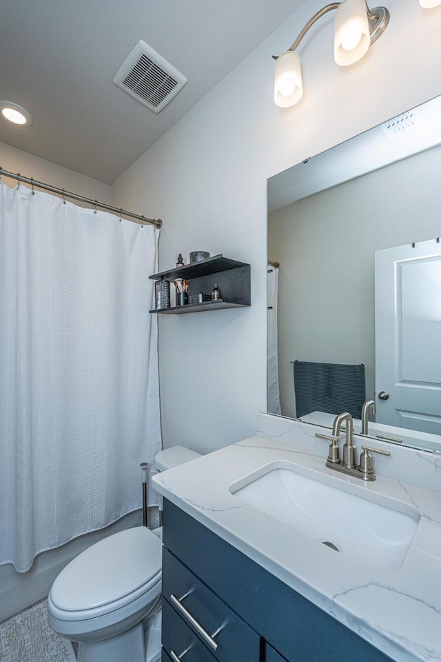 full bathroom with shower / bath combination with curtain, vanity, and toilet