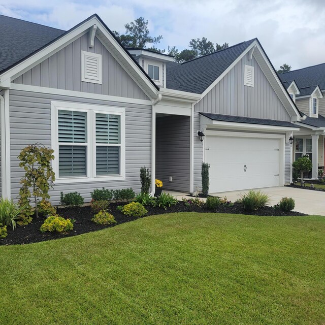 view of front of property with a garage and a front yard