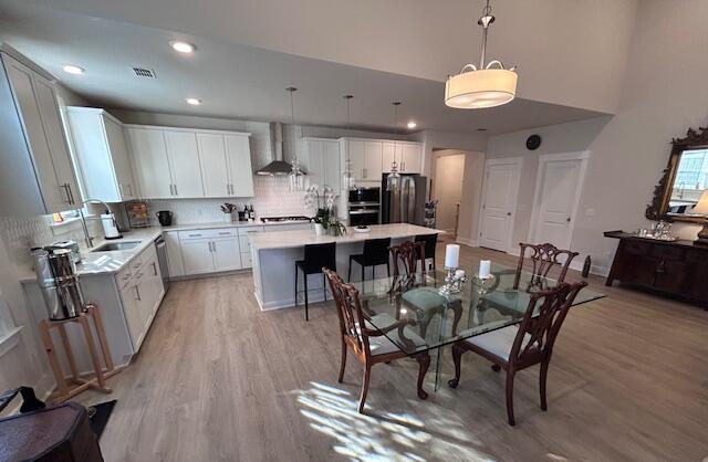 dining area featuring sink and light hardwood / wood-style flooring