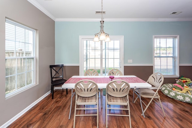 dining room featuring baseboards, visible vents, dark wood finished floors, and crown molding