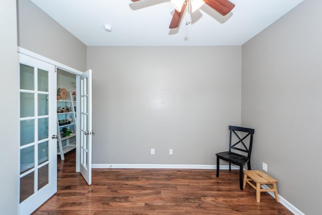 sitting room featuring ceiling fan, baseboards, dark wood finished floors, and french doors