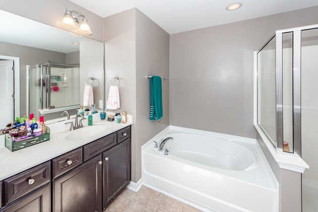 full bath with a bath, a stall shower, vanity, and tile patterned floors